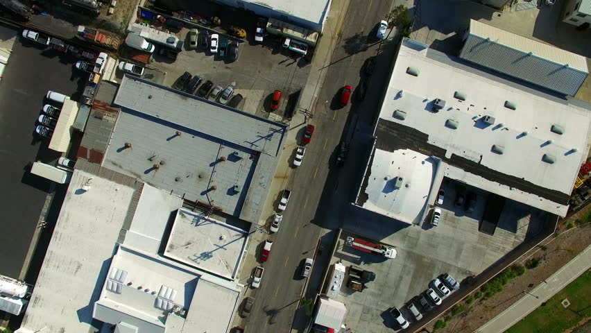 Aerial Top View Of Vehicles On Street Amidst Buildings, Drone Flying Forward Over City On Sunny Day - Long Beach, California