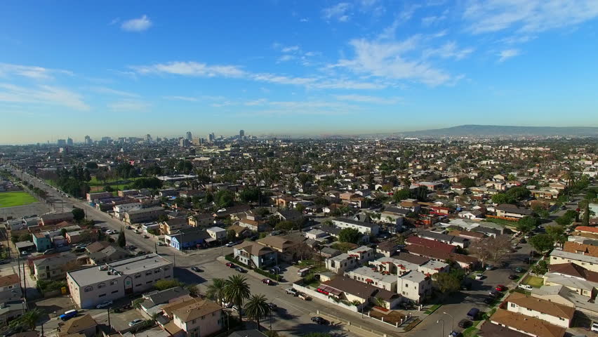 Aerial Shot Of Houses In Neighborhood Near Downtown Against Sky, Drone Ascending Over Suburb In City On Sunny Day - Long Beach, California
