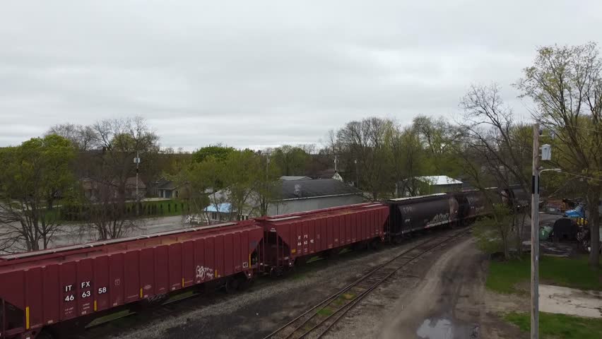 Aerial drone Train rural Michigan lowell michigan train cars train tracks red gray wide shot establishing shot 4k