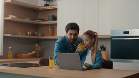 Caucasian dad father man with daughter child girl schoolgirl using laptop service together studying at home kitchen help e-learning watching movie play computer game drinking orange juice drink fresh - Powered by Shutterstock - Get 15% off with code: PIKWIZARD15