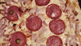 Pizza salami, ham and cheese. Freshly baked salami ham pizza with cheese. Spins beautifully. Video clips. Pizza smiley.