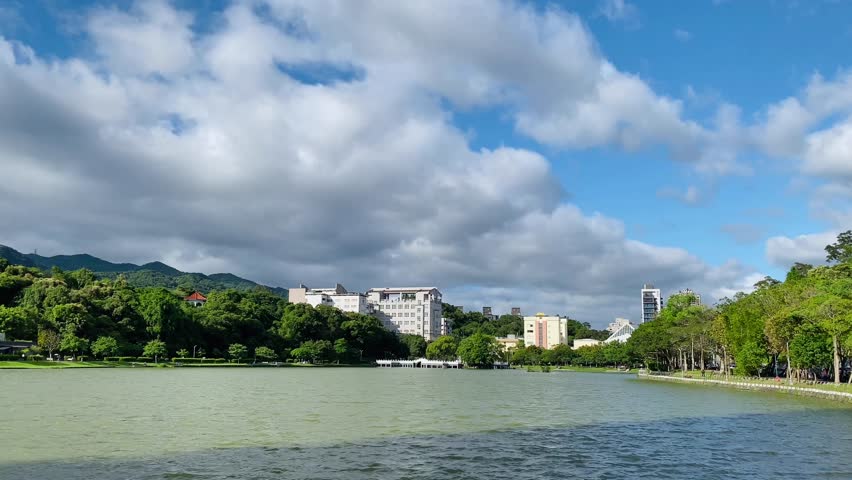 In the park in the afternoon on a sunny day, the lake is sparkling. The film was shot in Bihu Park, Taipei, Taiwan. Royalty-Free Stock Footage #1104681511