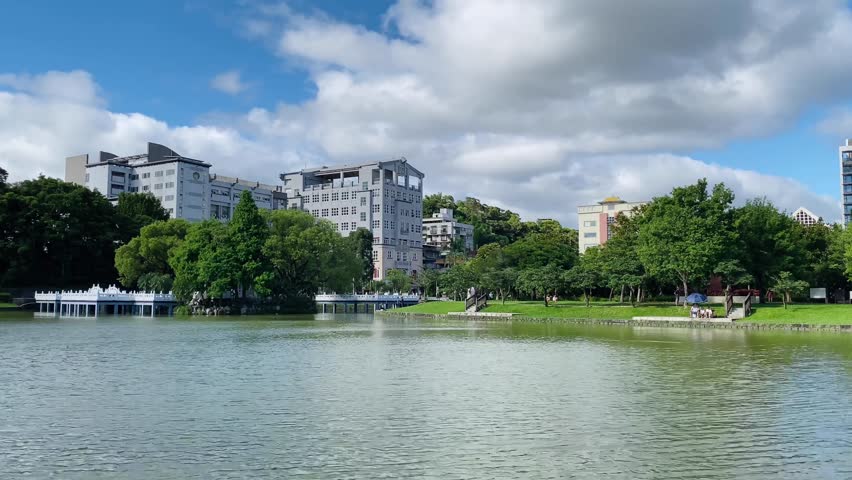 In the park in the afternoon on a sunny day, the lake is sparkling. The film was shot in Bihu Park, Taipei, Taiwan. Royalty-Free Stock Footage #1104681513