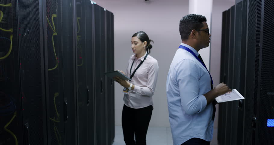 Cyber security check, server room and woman with tablet, man and network administration for database update. Tech employees, system maintenance and technician team online in data center together.