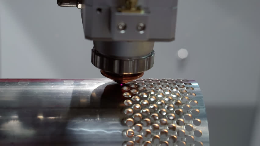 Modern equipment: automated CNC machine uses a laser to cut parts from sheet metal. The sparks fly in different directions. Laser cutting sheet metal on the production site. Royalty-Free Stock Footage #1104682779