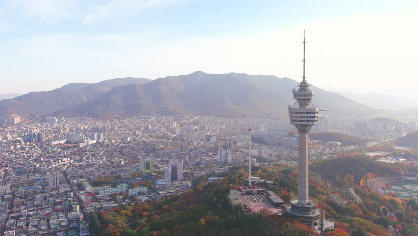Daegu: Aerial view of Metropolitan City in South Korea, Duryu Park in autumn colors and Daegu 83 Tower, sunny day - landscape panorama of Eastern Asia from above