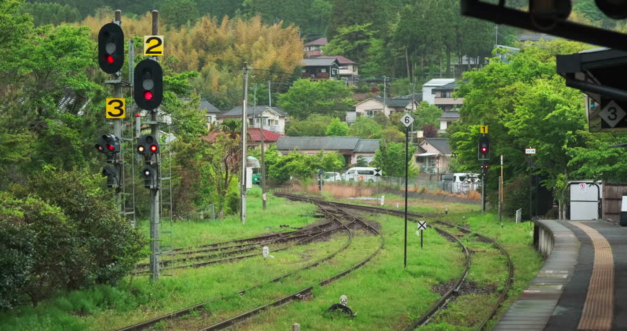 JR Kyushu's designed train Yufuin no mori heading to park among green scenery of Yufuin station, Oita, Japan, May 2023 Royalty-Free Stock Footage #1104688227