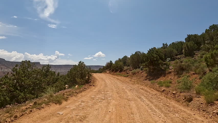 Mountain desert trail off road recreation Utah POV. Red rocks and sand, dry arid landscape. Rocky terrain and sand dunes. Fun and adventure riding in central Utah. Speed and obstacles. | Shutterstock HD Video #1104692361