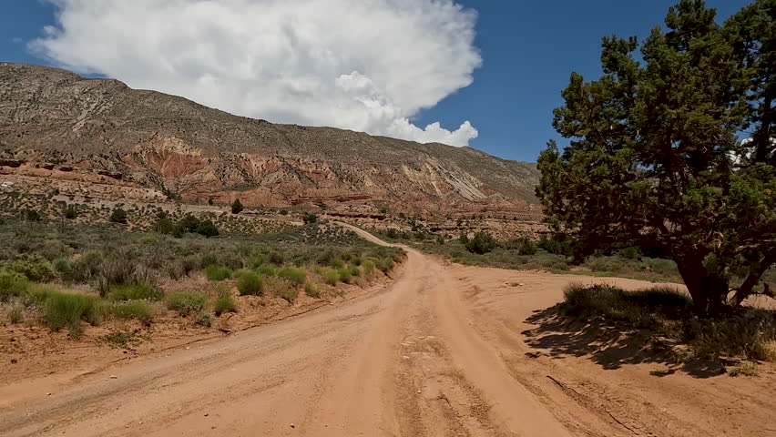 Mountain desert off road recreation Utah. Red rocks and sand, dry arid landscape. Rocky terrain and sand dunes. Fun and adventure riding in central Utah. Speed and obstacles. | Shutterstock HD Video #1104692363