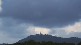 Time Lapse video, Sky and Black Clouds, Black clouds move rapidly over the big Buddha on high mountains in Phuket Thailand