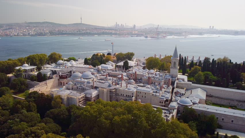 Awesome aerial view of the Topkapi Palace in Istanbul, Turkey. Drone flying over the city. The Bosporus is visible in background. Amazing cityscape. Royalty-Free Stock Footage #1104695437