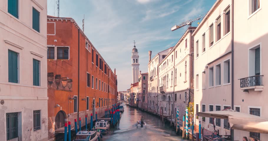 Timelapse View from Ponte de la Pieta of venetian canal and church of saint Giorgio dei Greci with boats and gondola passing by