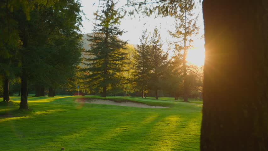Golf Course at Sunset. Beautiful green course, slow motion 4k  Royalty-Free Stock Footage #1104700731
