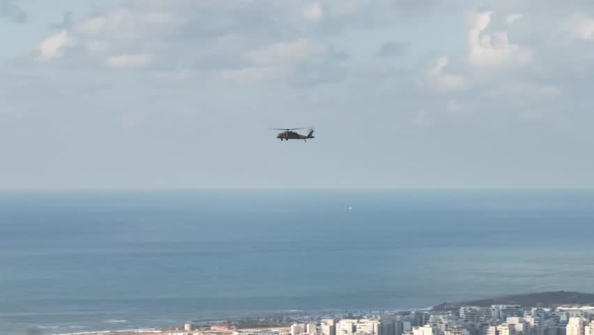 Blackhawk military helicopter patrolling and flying over the city . Royalty-Free Stock Footage #1104708513