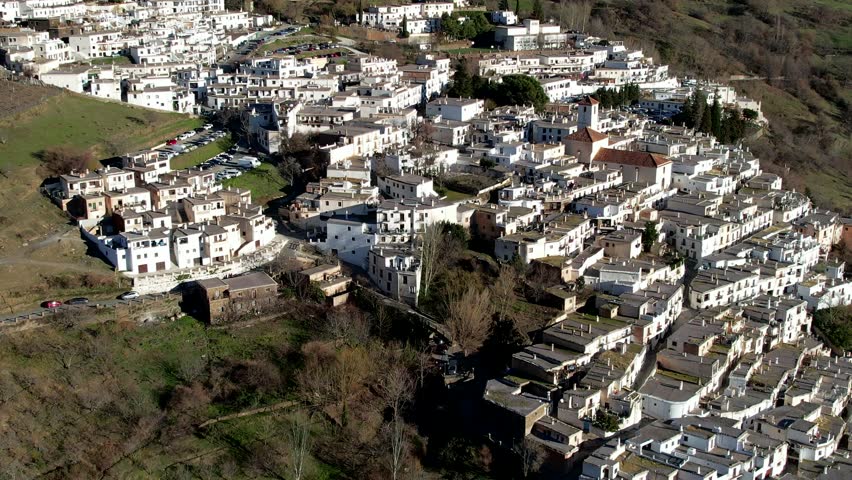 Capileira, Spain - January 26th 2023 - Aerial fly over above the beautiful village of Capileira in the Sierra Nevada Mountains in Andalusia Spain