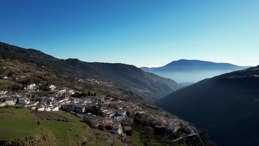 Capileira, Spain - January 26th 2023 - Aerial fly over above the beautiful village of Capileira in the Sierra Nevada Mountains in Andalusia Spain