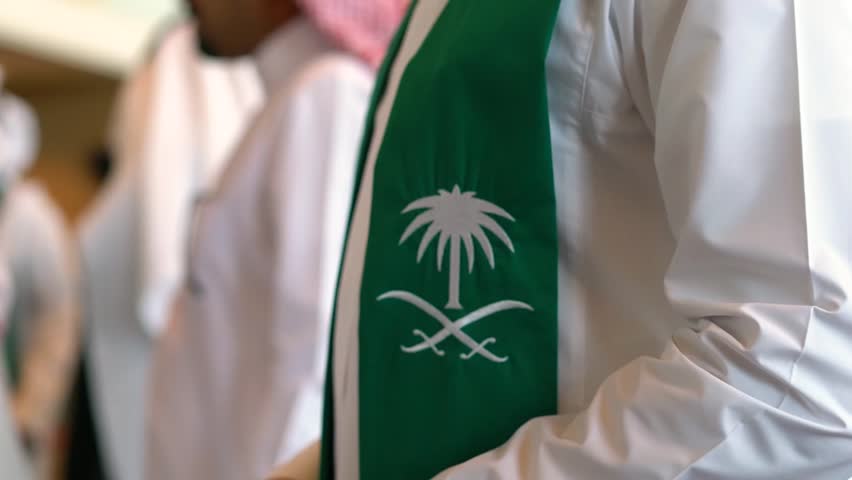 Man wear the flag of Saudi Arabia celebrate of national day of Kingdom of Saudi. closeup shot on the scarf Royalty-Free Stock Footage #1104711857