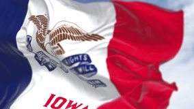 Iowa state flag waving. Three vertical stripes of blue, white, and red, with a bald eagle in the center. Seamless 3d render animation. Slow motion loop. Selective focus. Fluttering fabric. Close-up - Powered by Shutterstock - Get 15% off with code: PIKWIZARD15