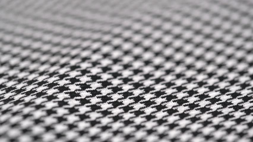rotation of the texture of tweed fabric houndstooth, classic woolen pattern close up. black and white houndstooth pattern. woven textile background. Royalty-Free Stock Footage #1104720585