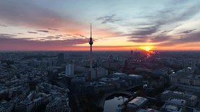 City of Berlin, Germany from above. Aerial cityscape view showing architectural landmarks Reichstag, TV Tower and Berlin Cathedral at sunrise. Drone flight to Alexanderplatz TV Tower, Sunflairs approx