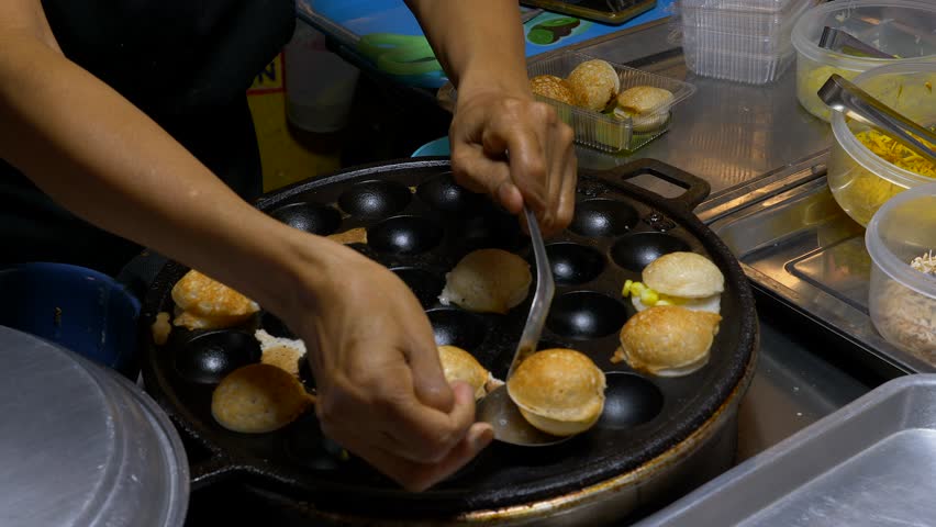 Sweet Coconut round small ball cakes flipped in a pan