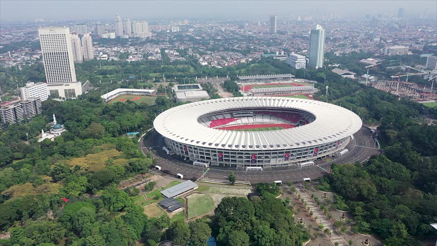 Aerial dolly shot of Gelora Bung Karno athletic stadium facilities in urban city center of Jakarta