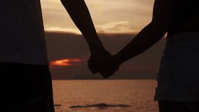 Love couple holding hands on sea sunset background. Close up silhouette man and woman touching hands together at sunset beach. Romantic couple couple holding each other hand's enjoying romantic date - Powered by Shutterstock - Get 15% off with code: PIKWIZARD15