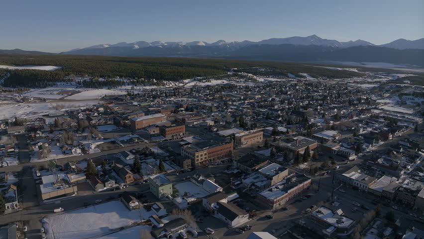 Leadville Aerial cinematic drone Colorado historic downtown winter spring snowy street buildings late afternoon early evening blue sky bright sunshine forward reveal movement