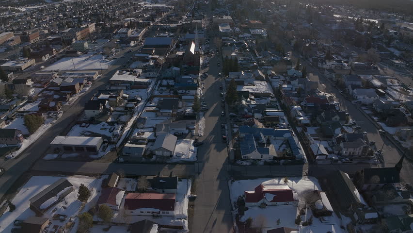 Leadville Aerial cinematic drone Colorado historic downtown winter spring snowy street buildings late afternoon early evening blue sky bright sunshine forward pan up reveal movement