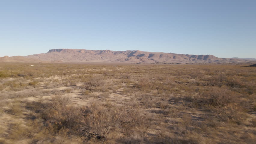 Aerial Drone Fly Close to Wide Desertic Dune Landscape of Big Bend National Park, Canyon over Blue Sky Background, Texas United States. Drone Shot of huge desert in Big Bend Texas Royalty-Free Stock Footage #1104743259