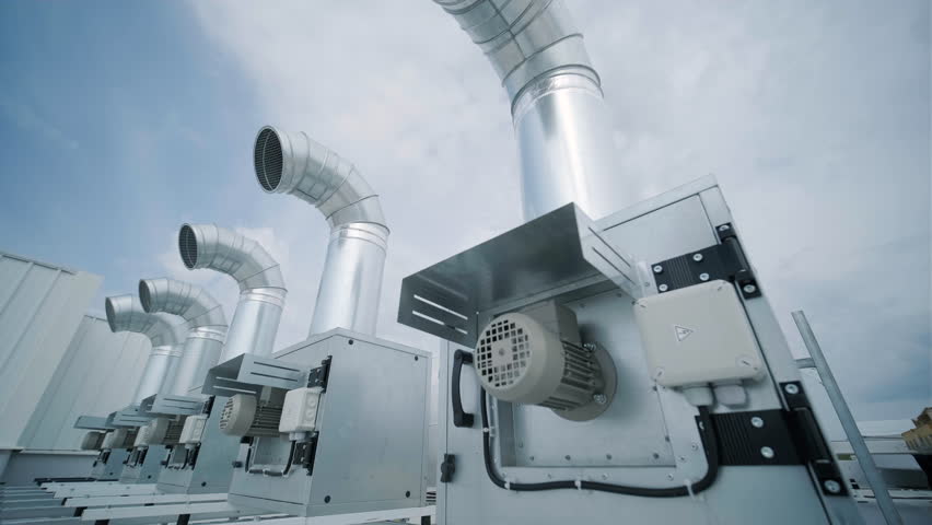 The air conditioning and ventilation system of a large industrial facility is located on the roof. It includes an air conditioner, smoke exhaust, and ventilation. Royalty-Free Stock Footage #1104744227