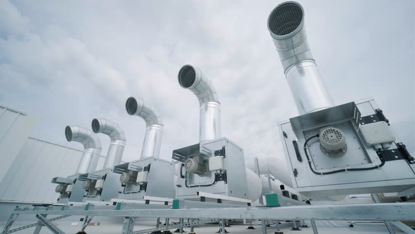 The air conditioning and ventilation system of a large industrial facility is located on the roof. It includes an air conditioner, smoke exhaust, and ventilation. Royalty-Free Stock Footage #1104744269