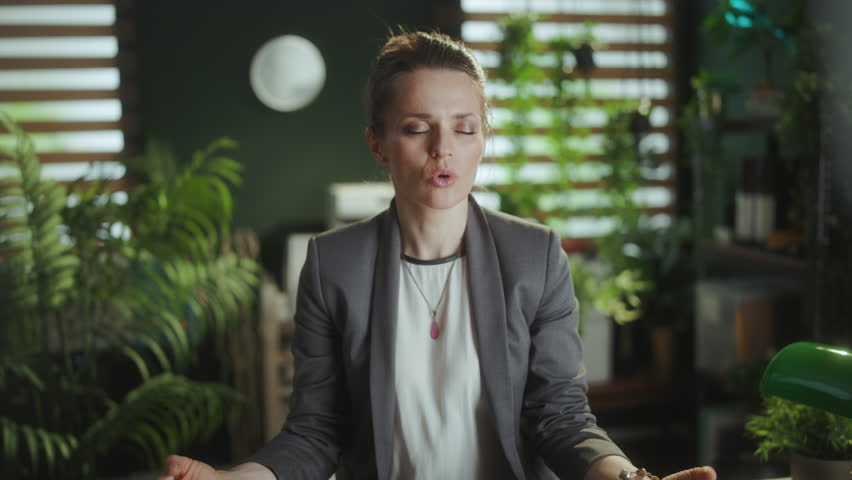 Sustainable workplace. relaxed modern business woman at work meditating.