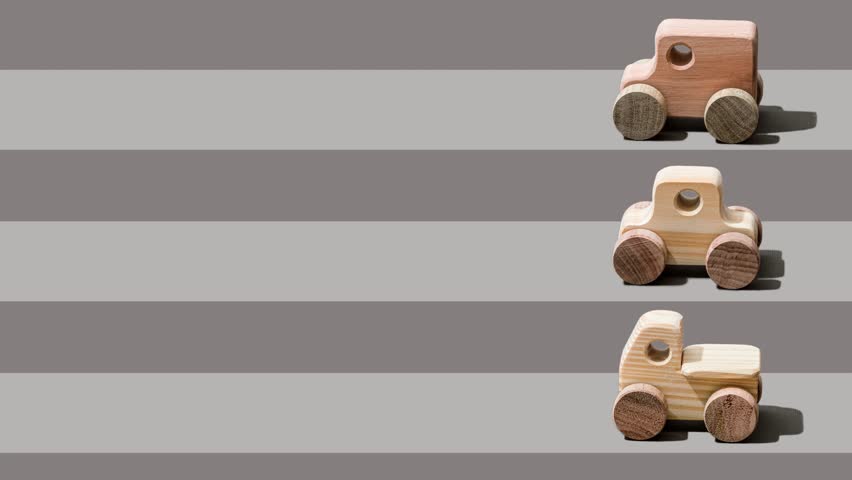 Stop Motion shot of wooden toy cars on a racing track