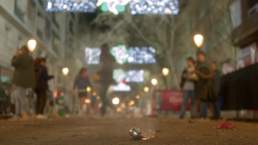 Children light firecrackers, creating a spectacle of sparks, light and smoke. Fallas in Valencia, Spain