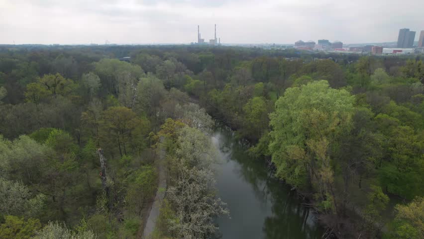 Aerial Shot Over Trees and River in Prater Park Revealing Skyline of Vienna, Austria Royalty-Free Stock Footage #1104756491