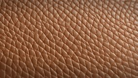 Luxury Brown Leather background texture. Slow panoramic camera motion, macro with deep blur (focus). High detailed 4K video.  Pattern texture surface panning background. 
