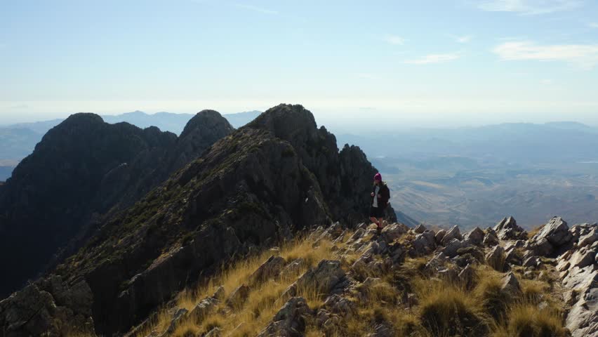 Person celebrating the end of a long hike on top of the Four Peaks mountains, in sunny Arizona - Aerial view