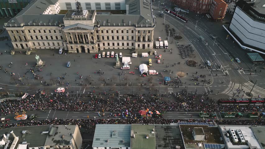 Aerial dolly left showcasing the Brunswick Festival floats driving through the crowds