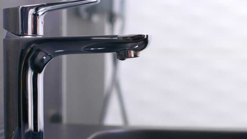 Oral Hygiene - Person Wetting Toothbrush With Toothpaste Under Running Water. - close up