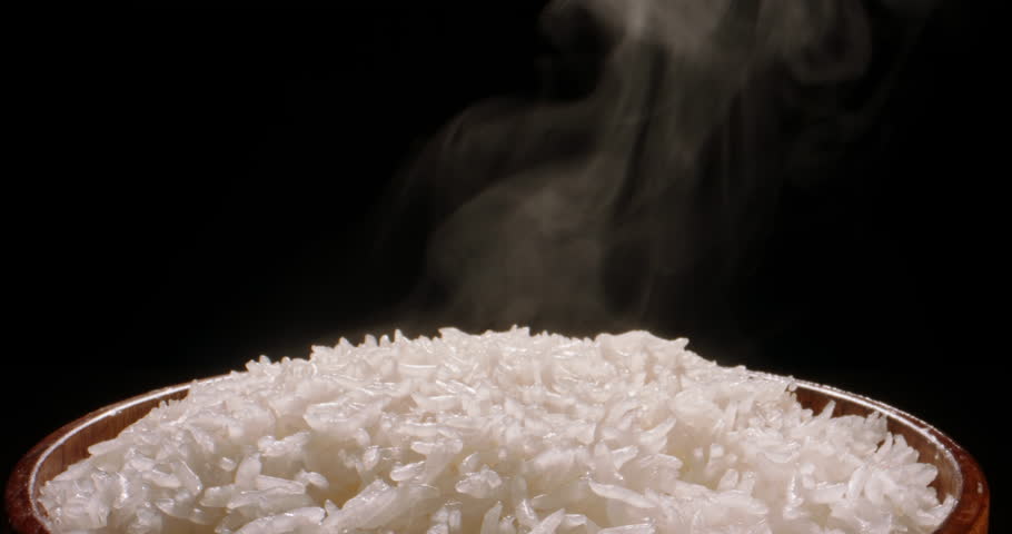 Hot white cooked rice steam bowl black background slow motion, Close up. Sticky rice after cooked. Asian Chinese Thai Japanese Indian traditional diet. Warm vegetarian healthy traditional food Royalty-Free Stock Footage #1104762617
