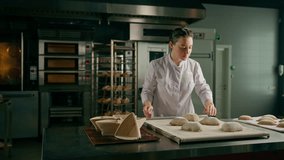 concentrated beautiful woman baker forms raw bread buns before baking bakery production pastries - Powered by Shutterstock - Get 15% off with code: PIKWIZARD15
