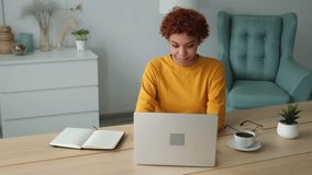 African american girl using laptop computer having video chat at home. Young woman having virtual meeting online chat video call conference sitting on couch. Work learning from home, remote teacher