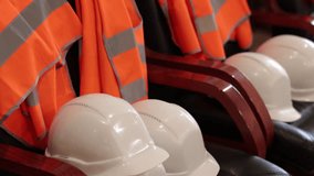 Engineering helmets, Signal vests, Plant safety. White hard hats orange safety vests employees plant stacked neatly ready pick up. - Powered by Shutterstock - Get 15% off with code: PIKWIZARD15