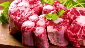 Close-Up of Raw Oxtail Meat Pieces on Wooden Surface | 4K Video of Fresh Ingredients for Savory Delights