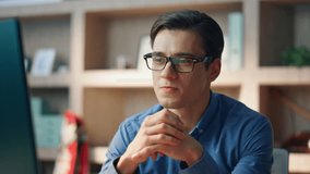 Smiling freelancer ending video chat at modern office closeup. Startup guy showing peace gesture at computer videocall. Creative business man talking with positive expression enjoying virtual meeting - Powered by Shutterstock - Get 15% off with code: PIKWIZARD15