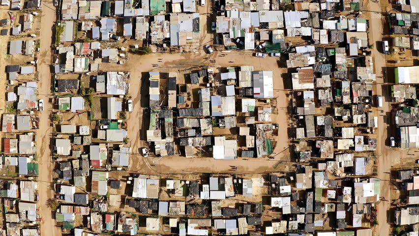 Environment, shacks and aerial view of a township in South africa with poverty in an outdoor rural area. Slum neighborhood, tin houses and drone of a poor community, location or village. Royalty-Free Stock Footage #1104773121