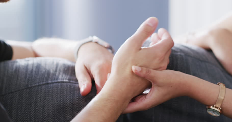 Trust, comfort and couple holding hands on sofa for support, compassion and empathy at home. Relationship, dating and closeup of hand of loving man and woman for care, bond and quality time on couch