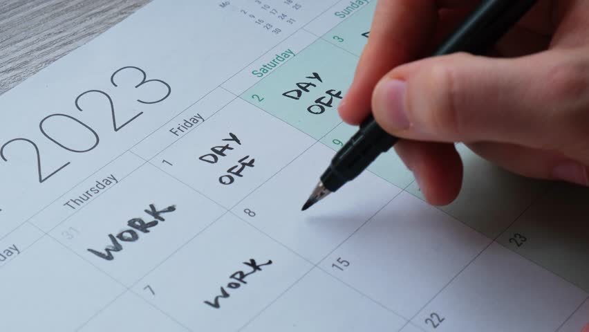 4 day work week printed calendar with weekend days four day working week concept. Female hand writing planning Modern approach doing business short workweek. Effectiveness of employees. Productivity Royalty-Free Stock Footage #1104776075
