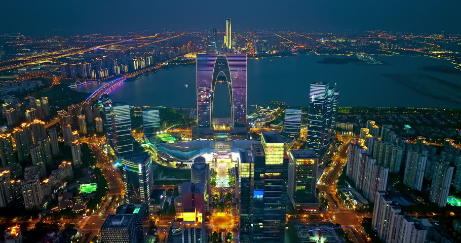 Aerial footage of city skyline and modern buildings scenery in Suzhou at night, China. Famous CBD building complex in Suzhou.